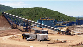 Pad Ore Recovery Conveyor and Stockpile with CCD Tanks in Background